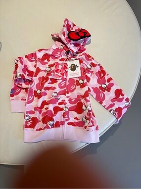 BAPE X Sanrio Hello Kitty Pink Camo Zip Hoodie with Bow Hood (children’s)